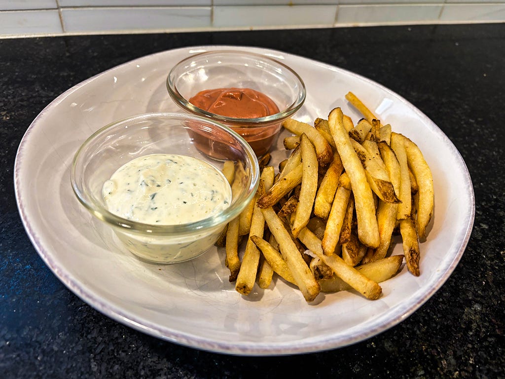 Fries and two sauces on a plate