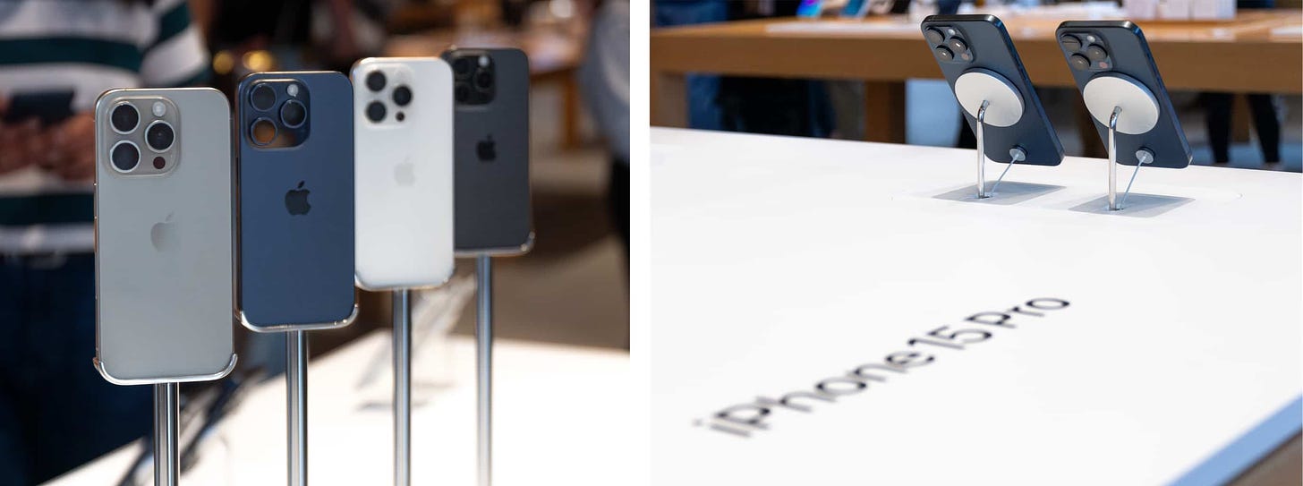 The iPhone Spotlight table at Apple Michigan Avenue. iPhone 15 Pro models are affixed to pedestals and presented on MagSafe risers.