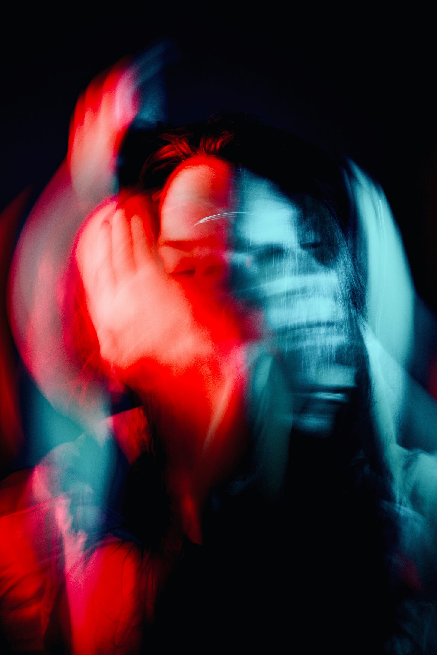 black, red, and blue blurred photo of a person