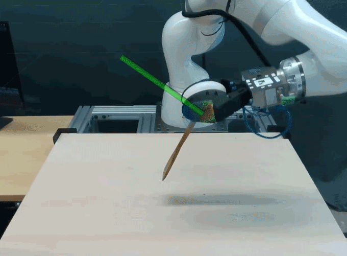 A robot holding a spatula presses it down on a table.