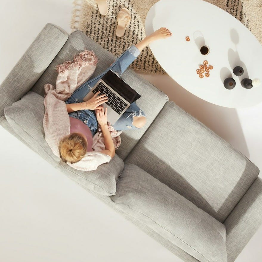 woman sitting on sofa woman sitting on sofa