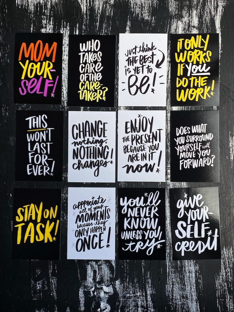 May include: Nine black and white cards with motivational quotes written in yellow and white paint. The cards have a black background and white borders. The quotes include: 'Mom your self!', 'Who takes care of the care taker?', 'Just think the best is yet to be!', 'It only works if you do the work!', 'This won't last for ever!', 'Change nothing. Nothing changes.', 'Enjoy the present because you are in it now!', 'Does what you surround yourself will move you forward?', 'Stay on task!', 'Appreciate all of your moments because they only happen once!', 'You'll never know unless you try', 'Give your self credit'. 