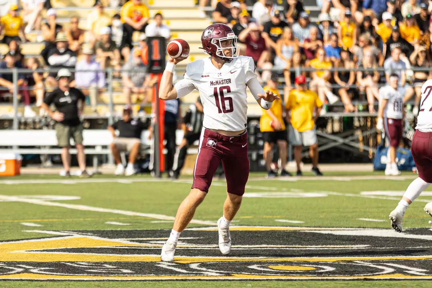 Football quarterback preparing to throw the football during a game.