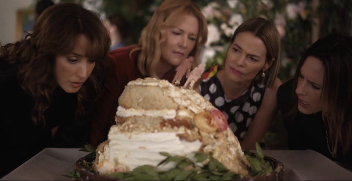 Bette, Tina, Alice and Shane looking at the cake