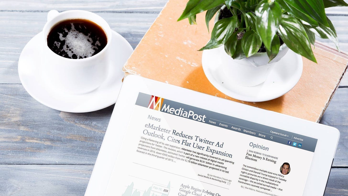 A cup of coffee next to a book and a newspaper

Description automatically generated