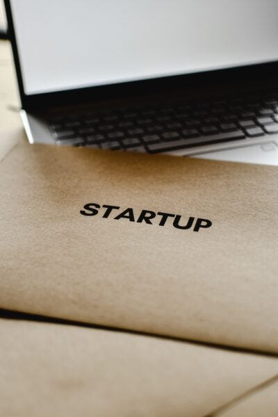 Image of envelope with Startup written on it with laptop 