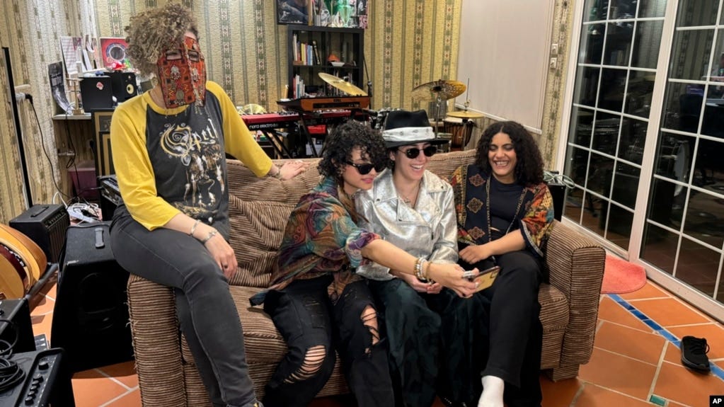 From left, members of the band Seera including Thing, Noura, Hayahuascah and Meesh take a selfie during an interview with The Associated Press in Riyadh, Saudi Arabia, May 12, 2024.