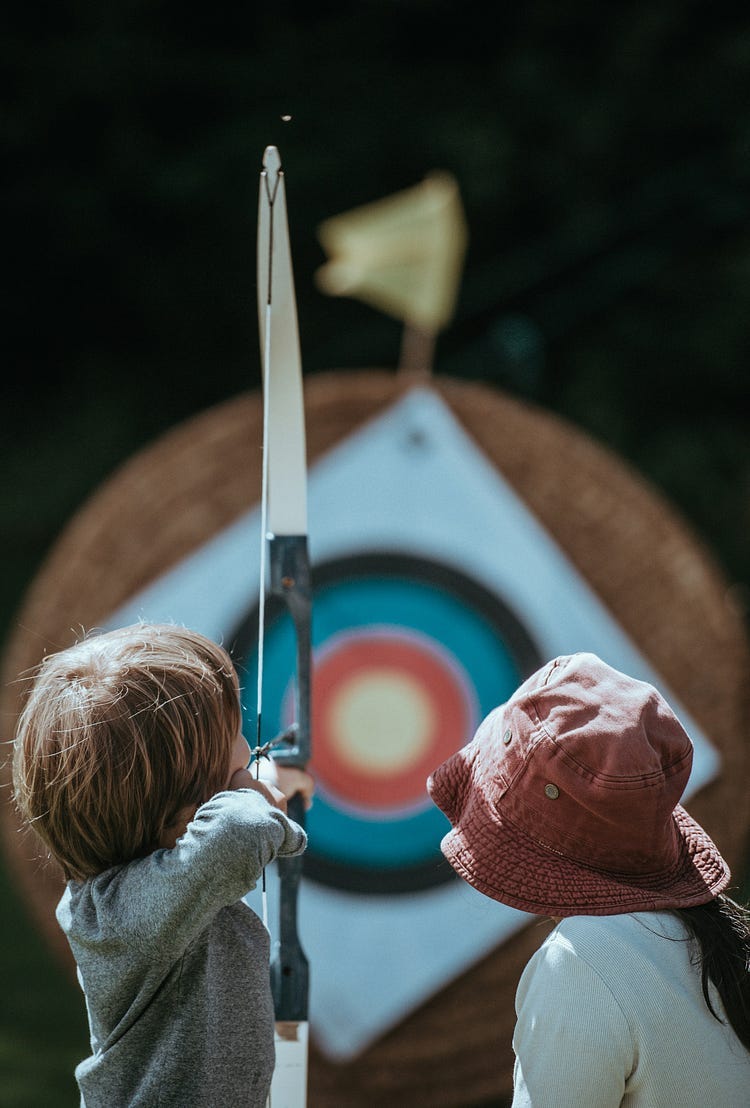 Boy shooting a Bow and Arrow.