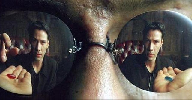 In "The Matrix" Neo is given a choice of Reality or wonderland. Reaches for  the red pill but isn't seen moving in the other lense. Showing he is "in  reality" reaching for