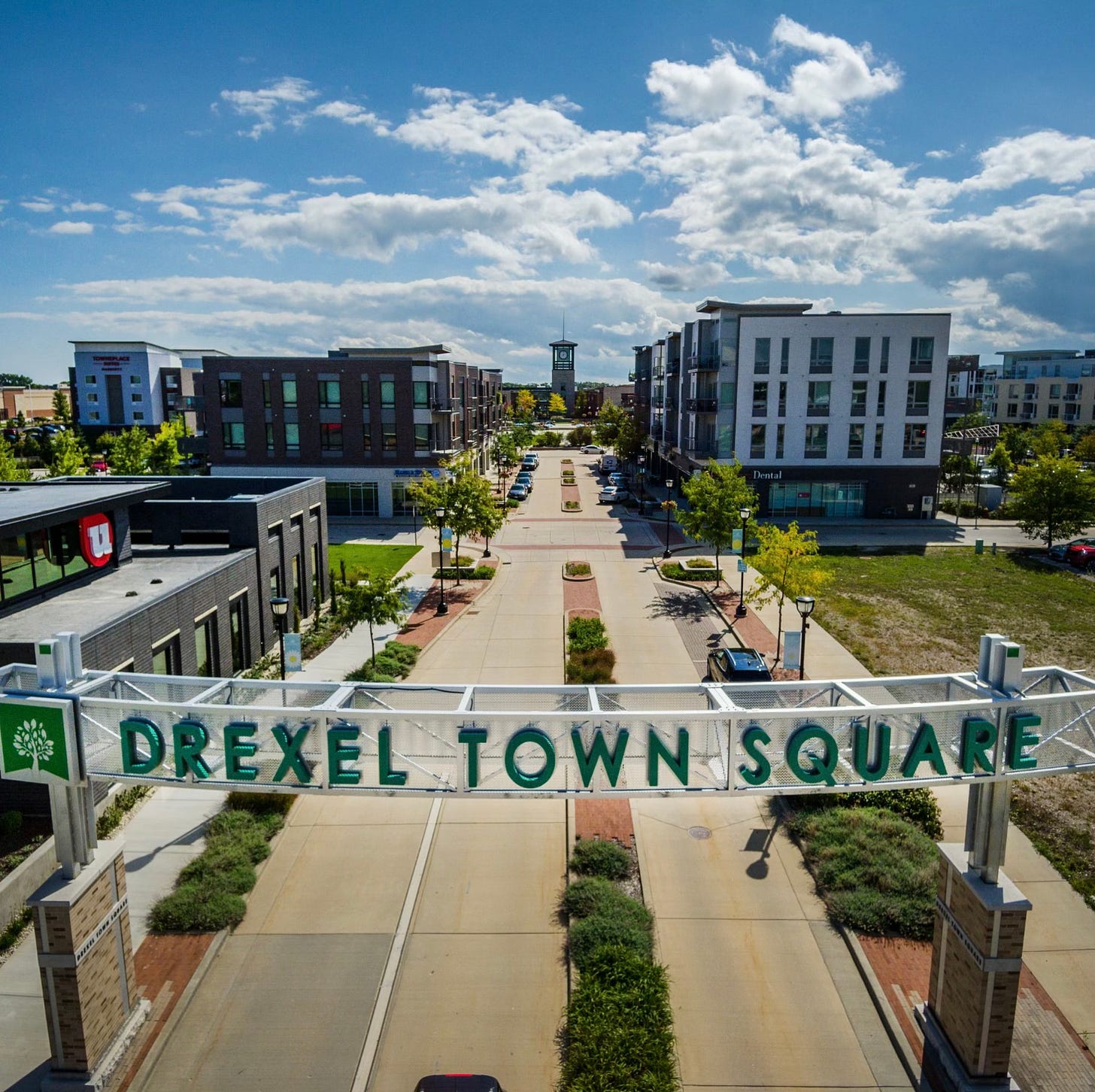 image of Drexel Town Square gateway sign and buildings, with clock tower in the distance