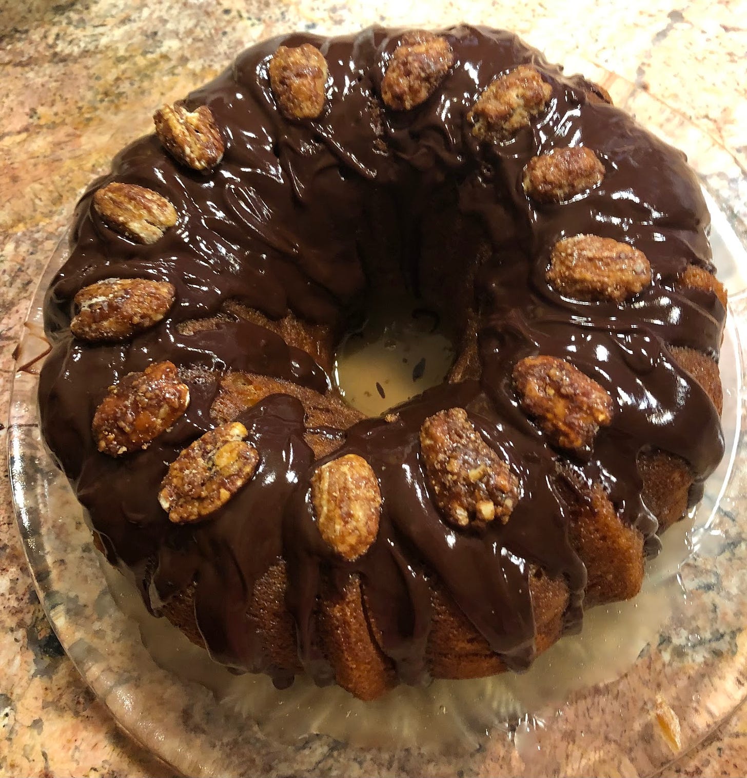 A rum cake--bundt cake with chocolate glaze and candied pecans.