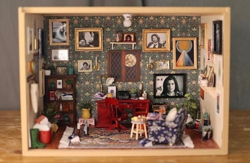 The miniature room Eliza made for Amber. It is filled with things that are relevant and meaningful to Amber's life (photos of friends and family, the books she's written, the "Y: The Last Man" graphic novel, etc.