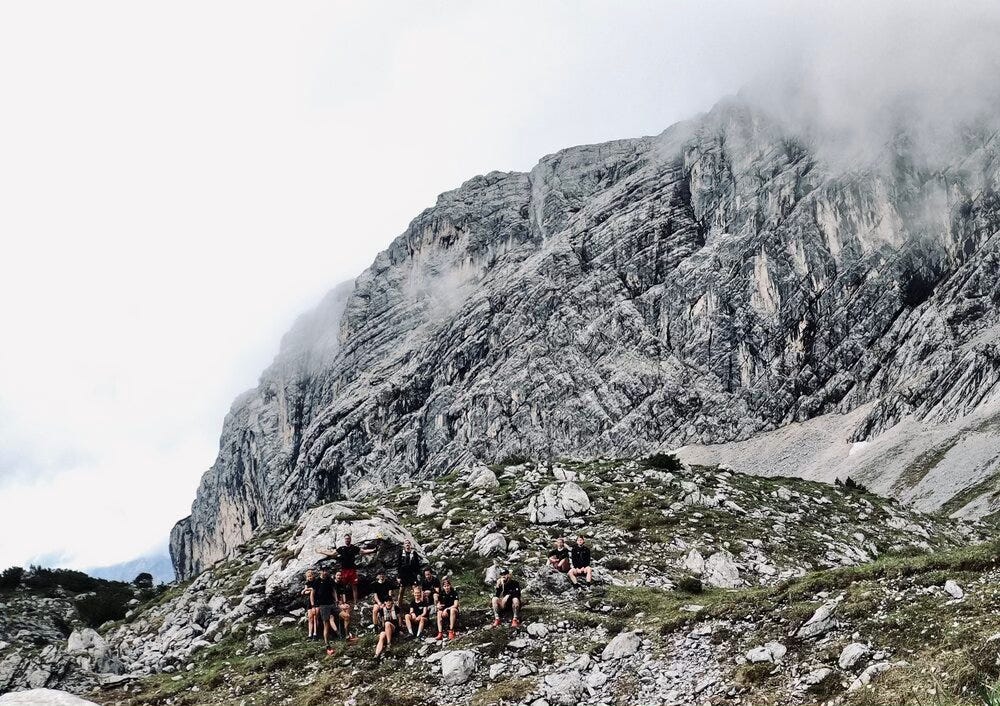 Willpower Athletes in front of a massive mountain range