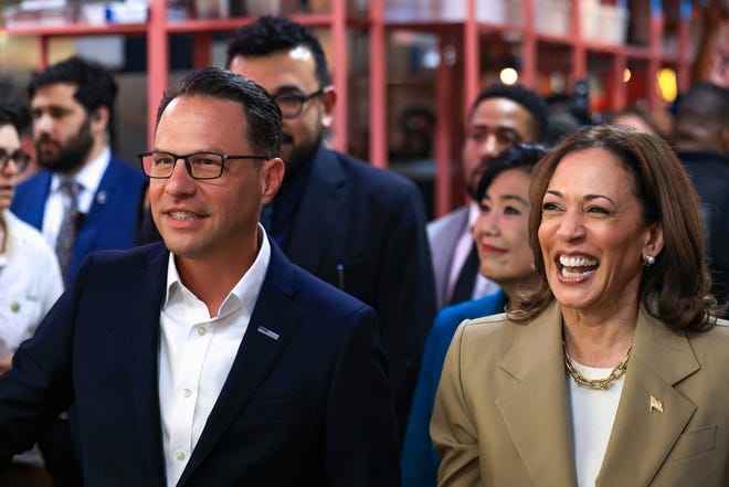 U.S. Vice President Kamala Harris and Pennsylvania Governor Josh Shapiro react during a visit to the Reading Terminal Market in Philadelphia, Pennsylvania on July 13, 2024.