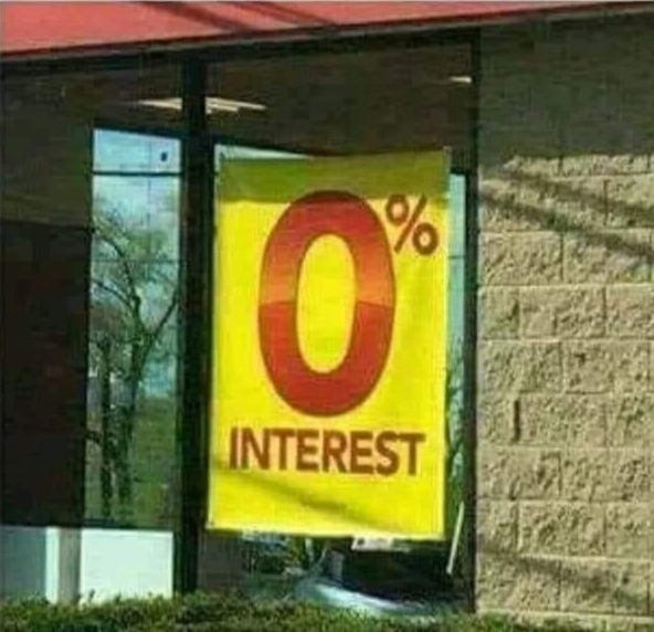image of sign in window that says 0% interest