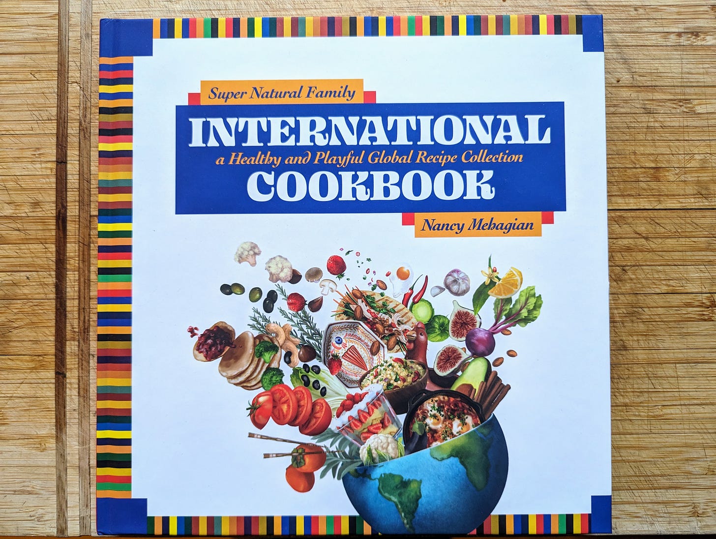 A picture of the Super Natural Family International Cookbook by Nancy Mehagian.