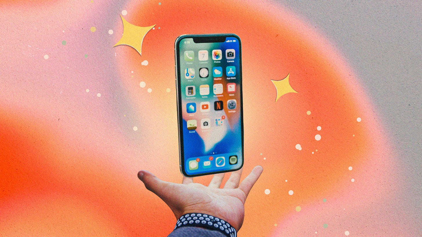 An iPhone is floating around stars above a hand with and orange and pink glowing background.