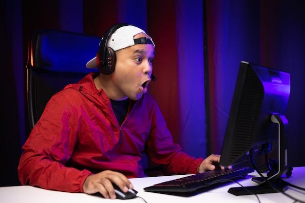 Excited and shocked face of Asian gamer with headphone playing computer pc  video game online sitting on chair at living room. Indian professional  gamer streaming on social playing game very fun |