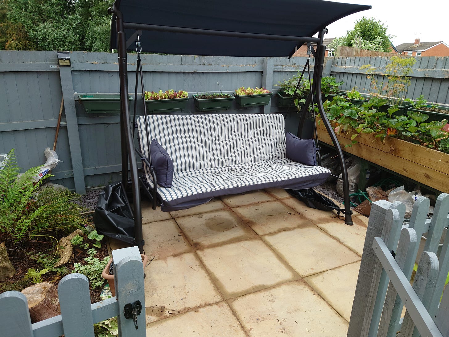 Photo of three seater swing on seating area