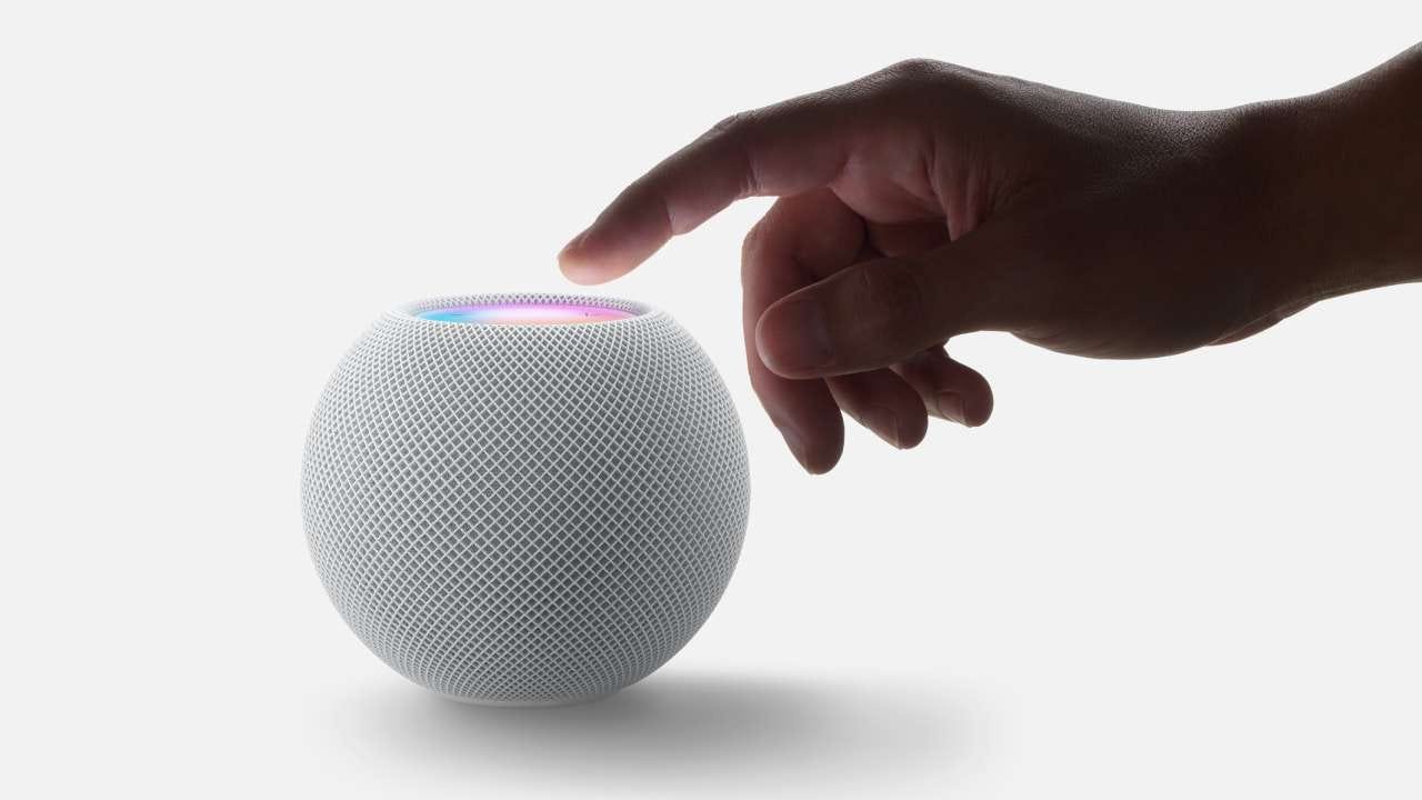 Man pressing the top of a HomePod mini