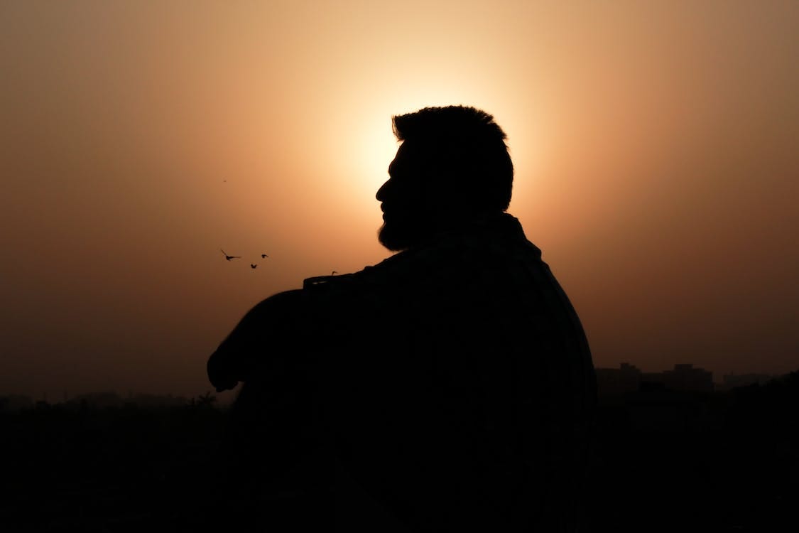 Pexels photo of a man silhouetted by the sunset by Pixabay.