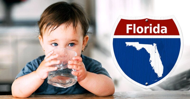 child drinking water and florida sign