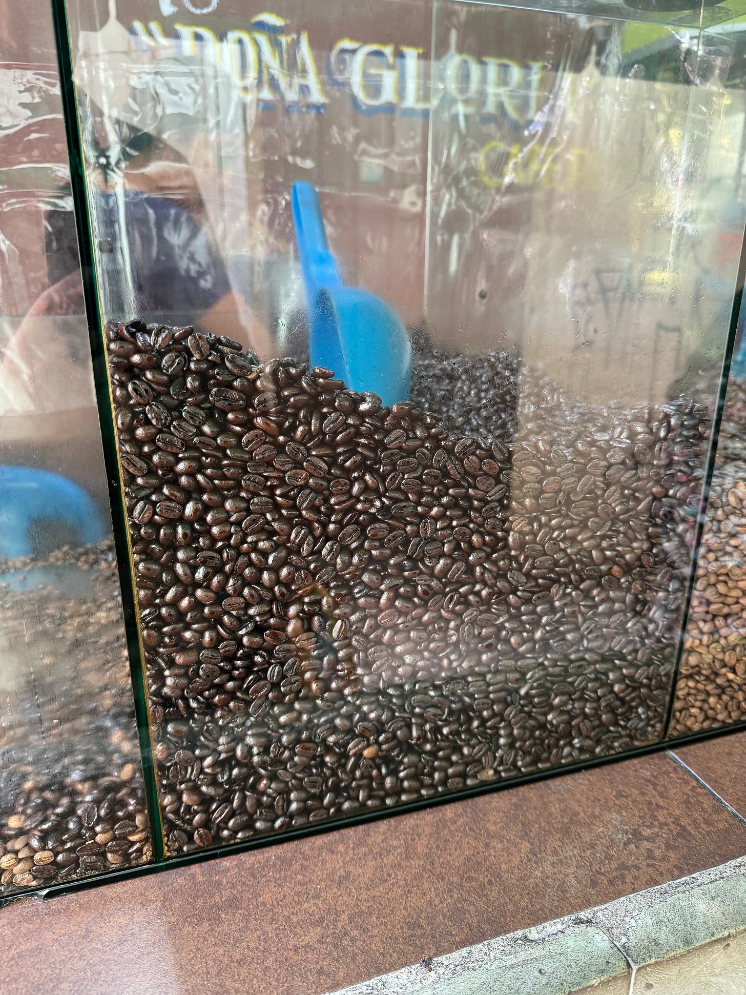 A class case holding coffee beans at a local market.