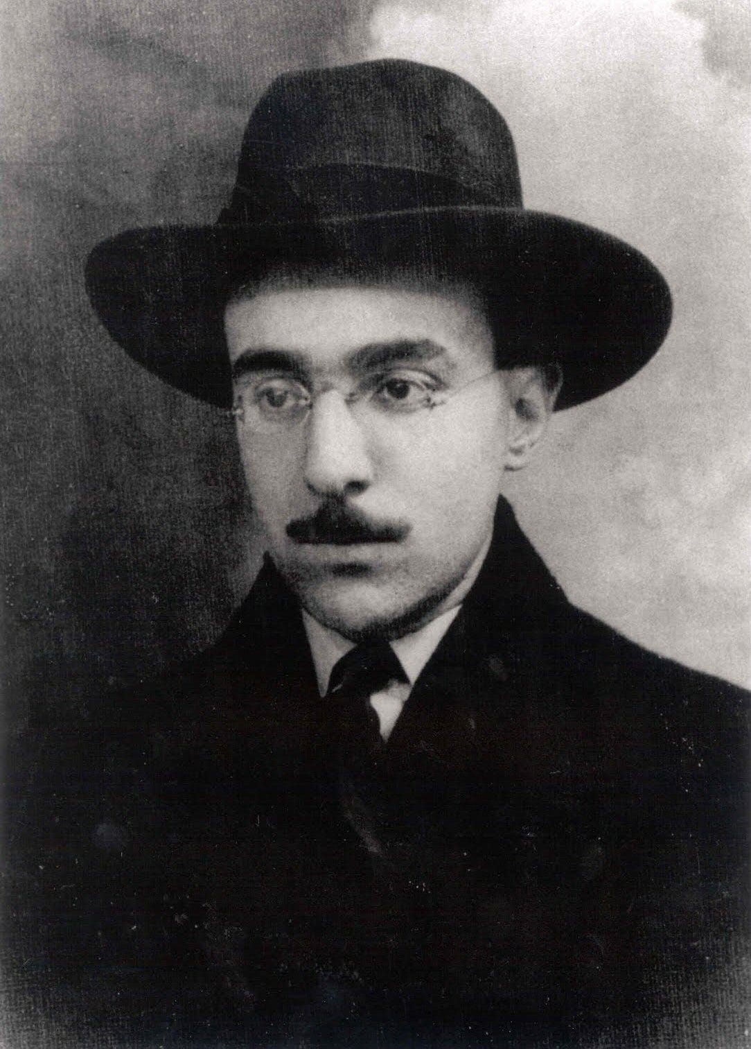 A black and white photograph of the poet and writer Fernando Pessoa.