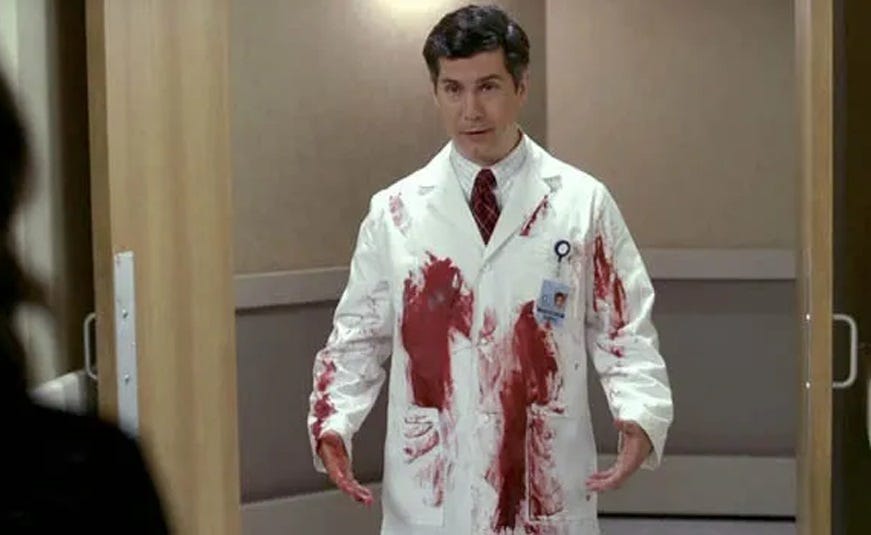 The character 'Dr. Spaceman' from 30 Rock, his lab coat covered in blood. 