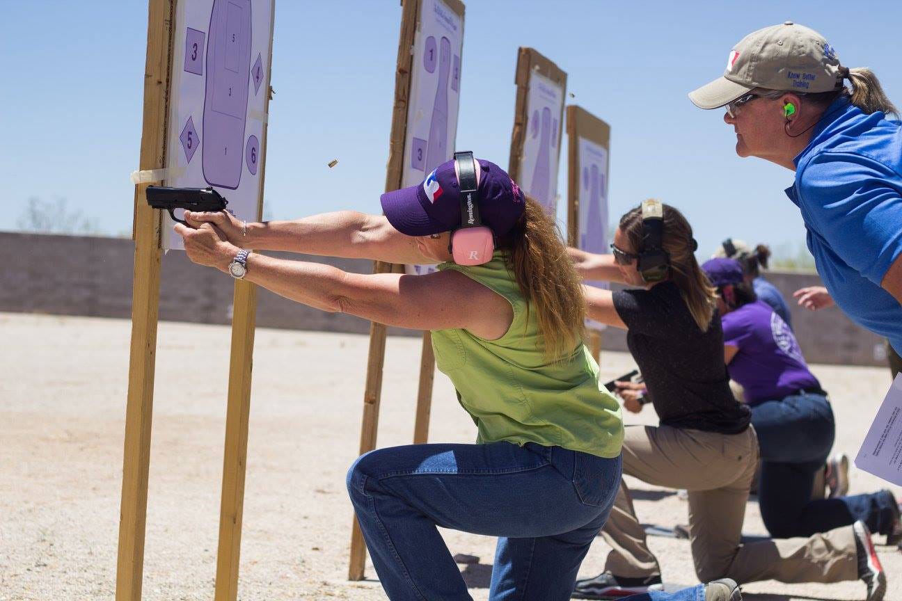 Women at a gun range learn how to shoot handguns as part of civil defense training, emphasizing the importance of self-defense skills.