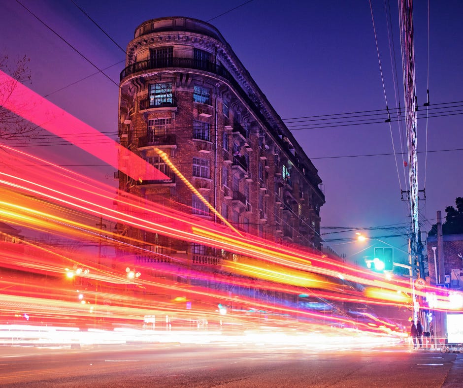 Car lights streaming down a busy city street