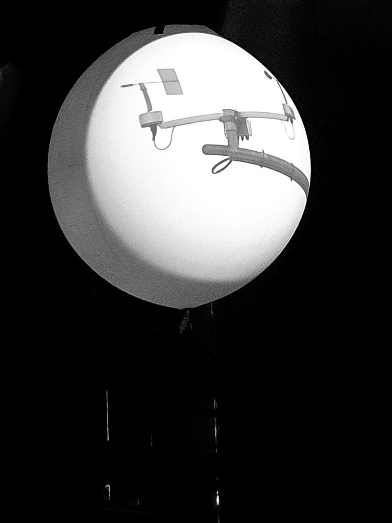 A weather ballon with a projected image of scientific instruments