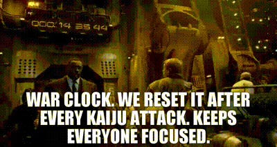 Screenshot of Pacific Rim. Stacker Pentecost in front of the War Clock saying "War Clock. We reset it after every Kaiju attack. Keeps everyone focused."
