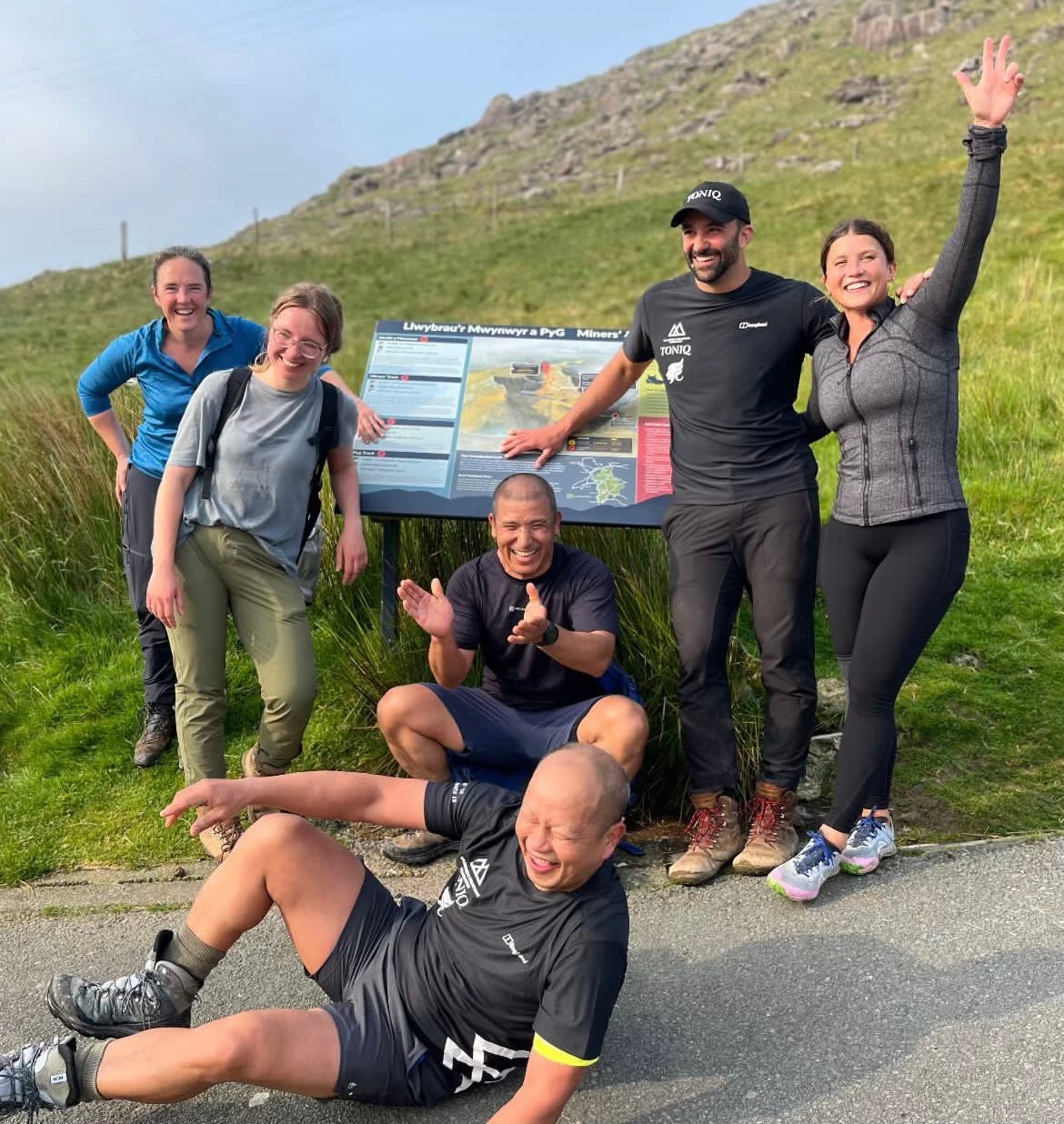 A photo of me and my team in front of the Snowdon sign, all of us looking very happy, joyful, and relieved.