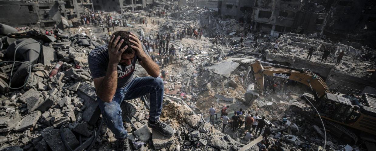 A man sits on the rubble as others wander among debris of buildings that were targeted by Israeli airstrikes in Jabaliya refugee camp, northern Gaza Strip. (Anadolu Ajansı - Ali Jadallah) 