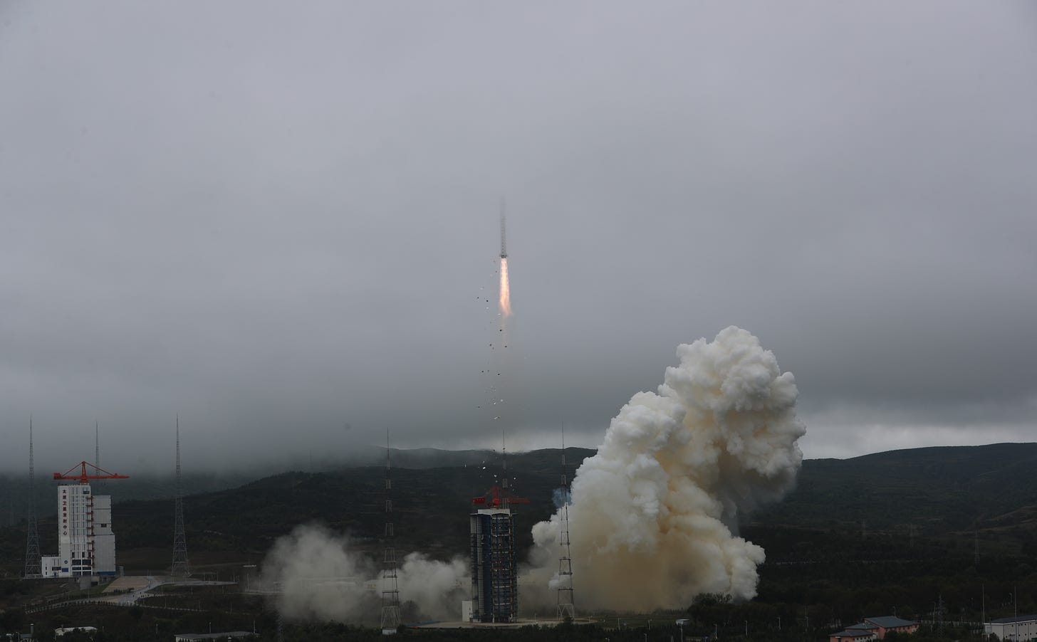 The Long March 2D carrying six Jilin-1 satellites disappearing into the clouds above the Taiyuan Satellite Launch Center.