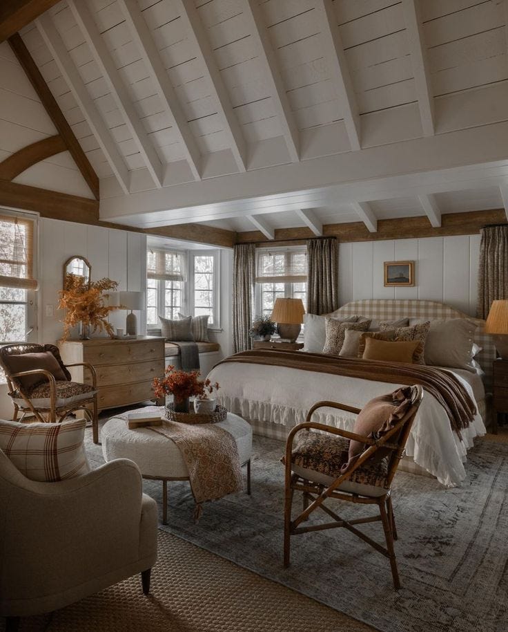 This may contain: a bedroom with a bed, chair, and ottoman in the middle of it's room This may contain: a bedroom with a bed, chair, and ottoman in the middle of it's room
