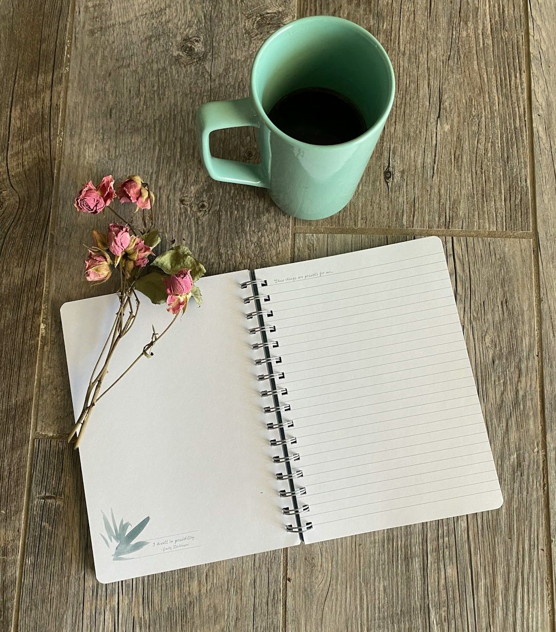 white notebook beside white ceramic mug on brown wooden table white notebook beside white ceramic mug on brown wooden table