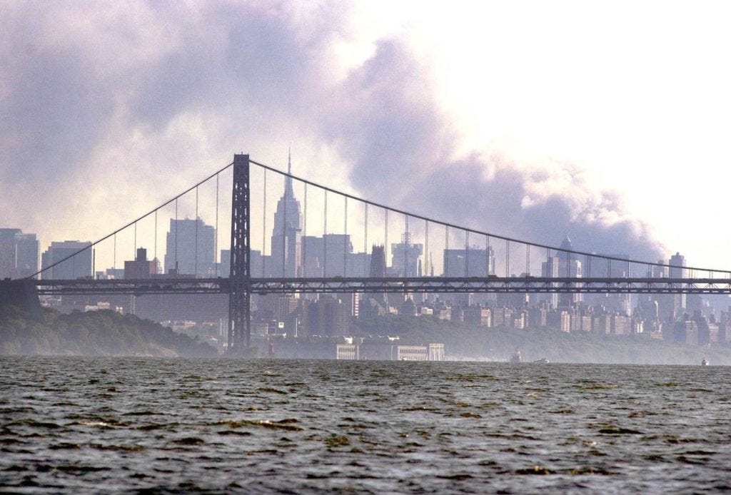 NEW YORK, UNITED STATES: Smoke rises from the New York skyline 11 September 2001 after two hijacked planes crashed into the landmark World Trade Center. US military forces worldwide were on their highest state of alert after the attacks against the World Trade Center and Pentagon, Pentagon officials said. AFP PHOTO/JOHN MOTTERN (Photo credit should read JOHN MOTTERN/AFP/Getty Images)