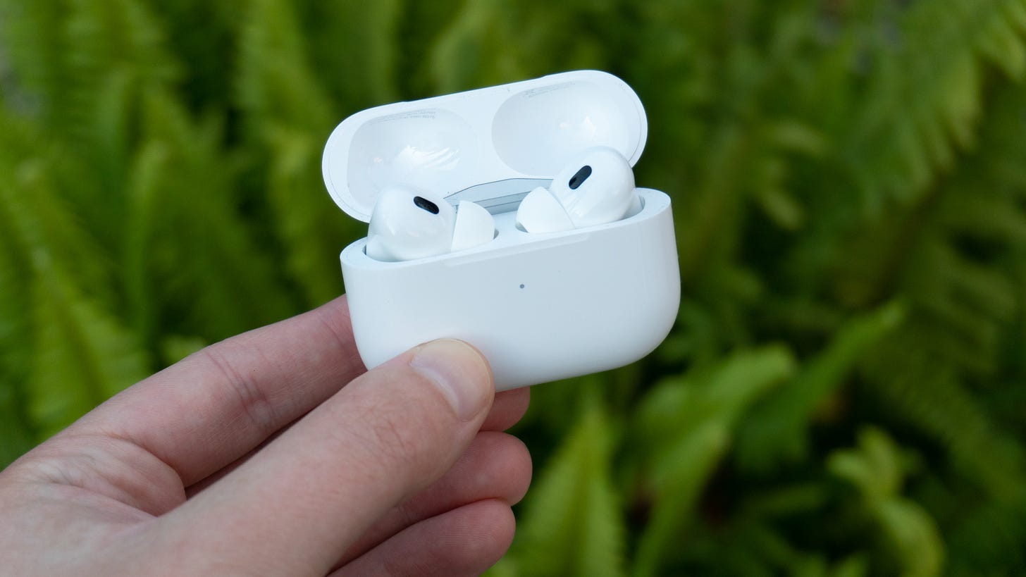 Apple AirPods Pro second-generation against a green background.