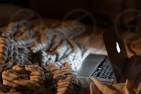 Using laptop at night in bed by Lesia Valentain. Photo stock - StudioNow