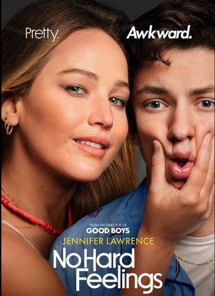 Movie poster for No Hard Feelings showing Jennifer Lawrence squeezing the face of an awkward young man. Tagline: Pretty. Awkward.