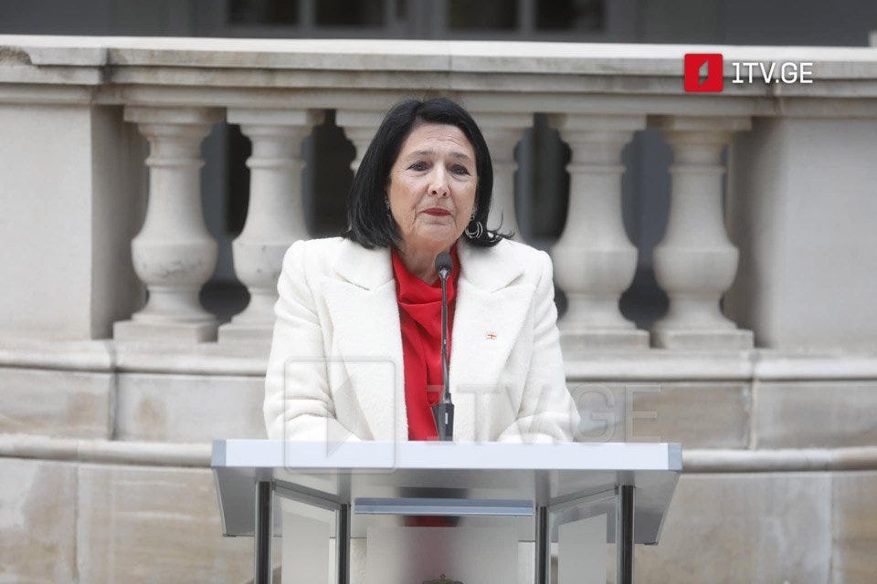 Salome Zourabichvili addressing protesters as she leaves the Presidency, wearing the colors of the Georgian flag.