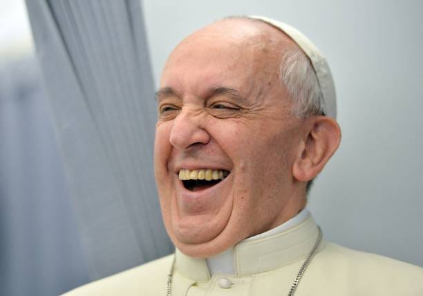 Pope Francis laughs while addressing journalists of the papal flight, upon arrival in Rio de Janeiro on July 22, 2013. Pope Francis landed in Brazil...
