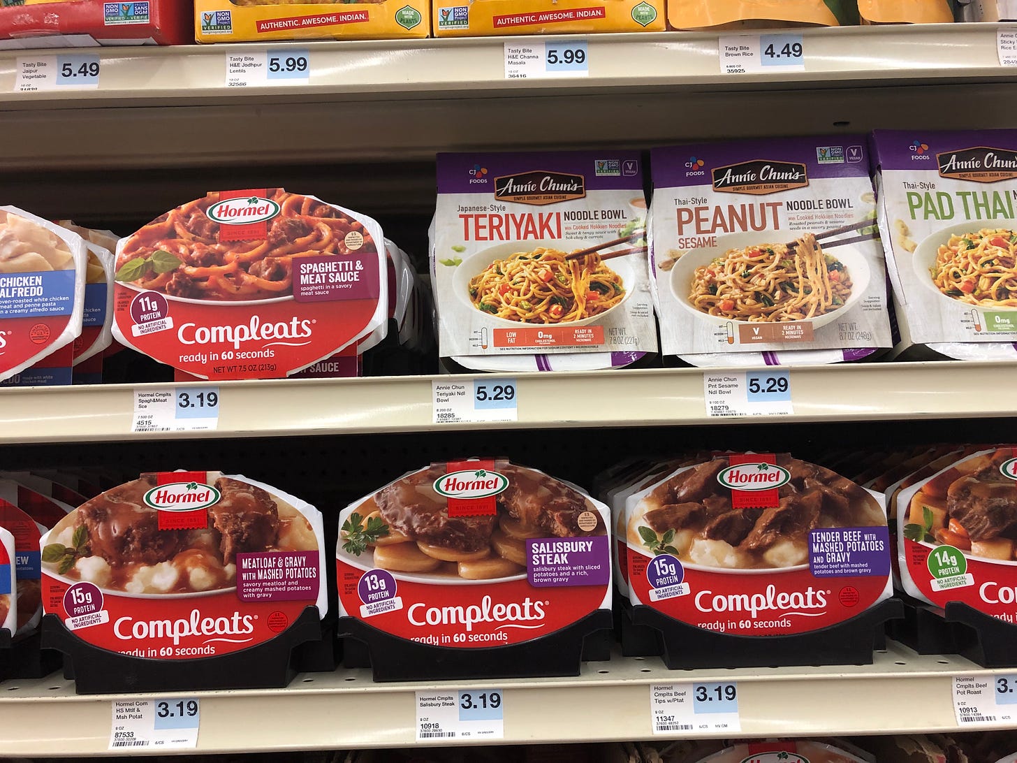 Microwave meals on the grocery shelf for 5.99, 3.19, 4.49, and 3.19