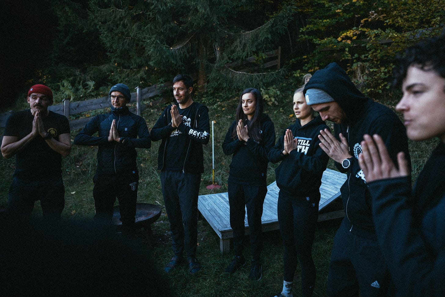 The willpower athletes standing in a circle looks like they're praying