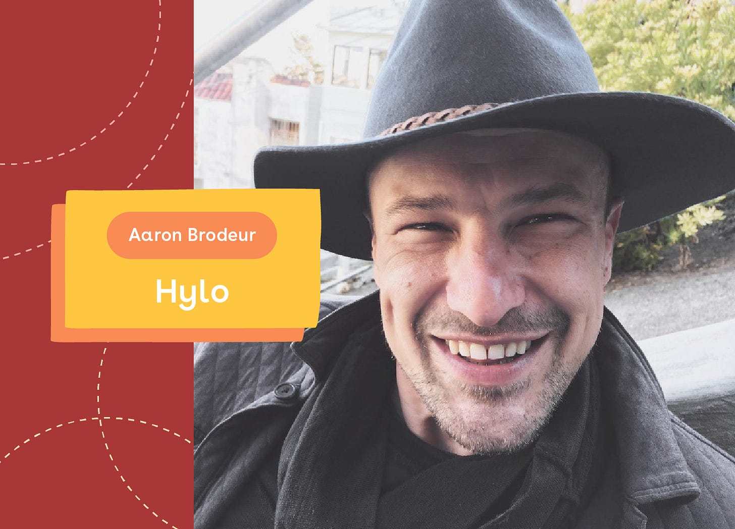 A close-up portrait of Aaron Brodeur, co-founder of Hylo, smiling broadly while wearing a wide-brimmed dark hat and dark jacket. The image features a stylized design with a red background on the left side decorated with dotted curved lines, and a yellow text box identifying him as "Aaron Brodeur" and "Hylo." This friendly, approachable image highlights the person behind the community-focused platform that combines tools for communication and collaboration.
