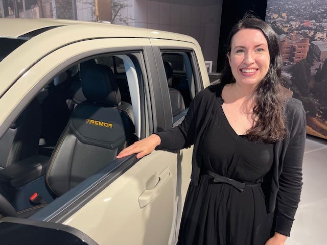 Kristen Keenan, color and materials designer at Ford Motor Co., stands with 2025 Maverick pickup on July 26, 2024, after a media briefing in Detroit.