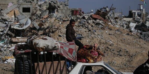 A family travels through Rafah in the southern Gaza Strip in a vehicle packed with their belongings.