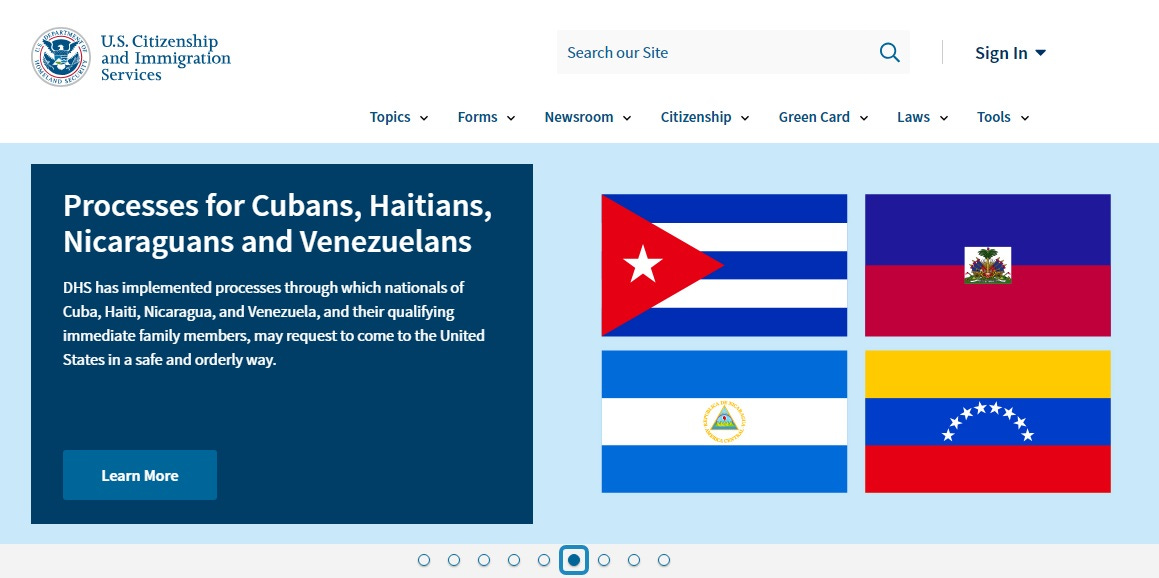 Screenshot of USCIS homepage heading 'Processes for Cubans, Haitians, Nicaraguans, and Venezuelans,' with images of those countries' flags and the text 'DHS has implemented processes through which nationals of Cuba, Haiti, Nicaragua, and Venezuela, and their qualifying immediate family members, may request to come to the United States in a safe and orderly way.' 